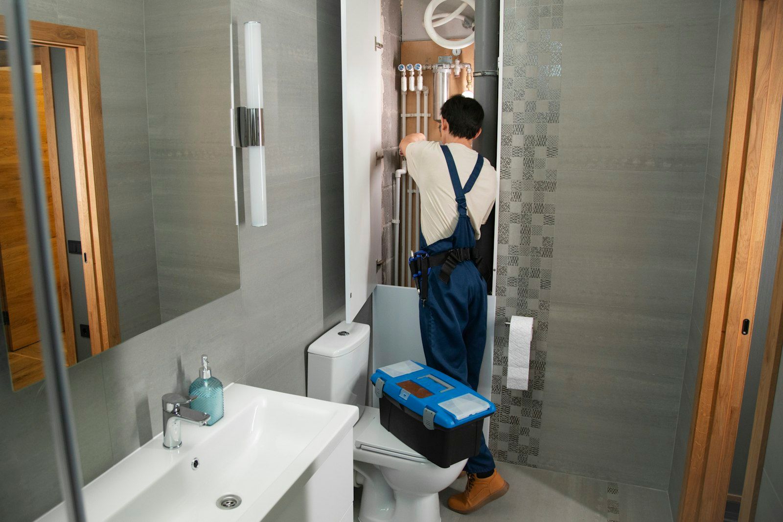 Licensed plumber repairing pipes on a residential plumbing job in Warwick